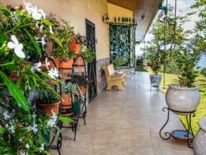 Porch with potted plants, garden view, and seating in Dominical, Costa Rica.