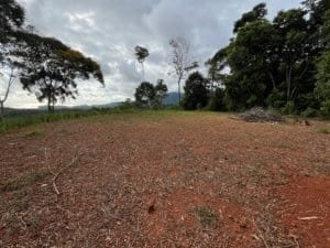 Ridge top land with panoramic ocean view, Costa Rica hillside terrain and surrounding trees.