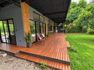 Modern tropical home with wooden deck, pool, and lush garden in Dominical.
