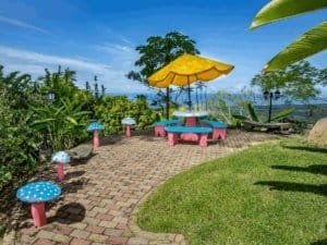 Colorful mushroom-shaped garden decorations with umbrella and scenic view.