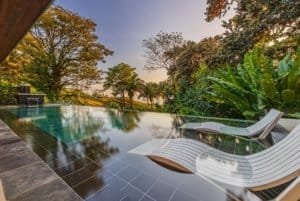 Ocean view pool with lounge chairs in a tropical Costa Rica villa.