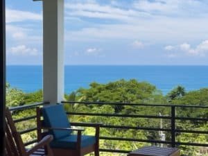 Balcony view of the ocean and lush greenery in Dominical, Costa Rica.