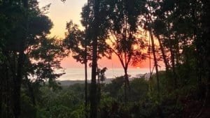 Scenic mountain view with ocean in the distance at sunset in Dominical, Costa Rica.