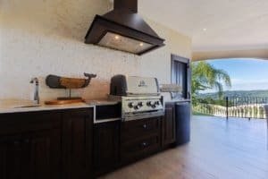 Modern outdoor kitchen with ocean and mountain views in Costa Rica.
