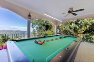 Covered patio with pool table, ceiling fan, and scenic ocean view in Dominical.