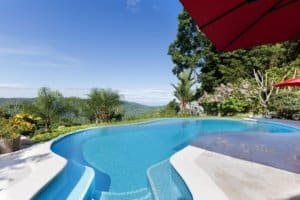 Gated community luxury home in Costa Rica with pool, ocean, and mountain views.