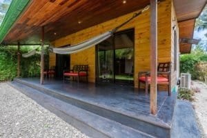 Turn-key 2-bedroom coastal home porch with hammocks and wood decking.