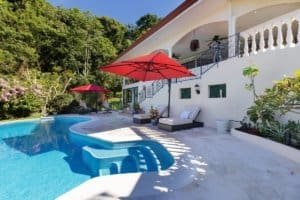 Beautiful pool area of a luxury home in Costa Rica with ocean and mountain views.