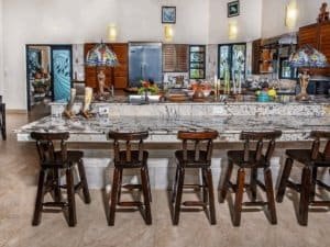 Spacious Costa Rica estate kitchen with marble island and tropical decor.