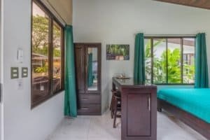 Turnkey 3-bedroom villa in Dominical with pool, bright bedroom, and dining area.