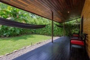Covered porch with seating overlooking lush tropical garden in Dominical.