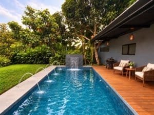 Luxury tropical home with private pool and outdoor seating near the beach.