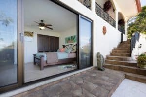 Bedroom with ocean view, sliding glass door, and modern decor in Costa Rica.