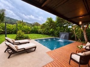 Relaxing pool area with loungers and lush greenery in Dominical.
