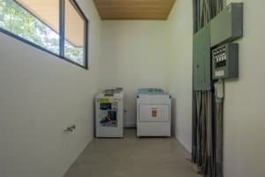 Laundry room with washer and dryer, Costa Rica real estate investment image.