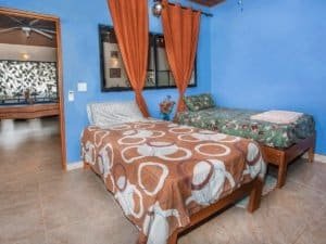 Comfortable bedroom with colorful bedding and tropical decor in Dominical.