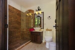 Modern bathroom with walk-in shower, vanity, and toilet in Costa Rica.