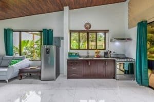 Spacious kitchen and seating area in Dominical Costa Rica villa with modern appliances.