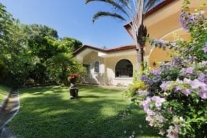 Beautiful Costa Rican home with lush garden and mountain view.