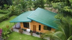 Turn-key coastal home with green roof, wooden exterior, tropical landscaping in Dominical, near the.