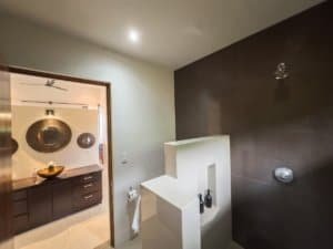 Contemporary bathroom with shower, minimalist decor, and neutral tones.