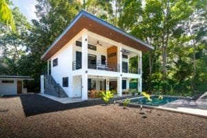 Dominical Costa Rica modern two-story villa with pool and lush greenery.