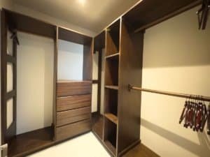 Spacious walk-in closet with wooden shelves and hanging space in Costa Rica.