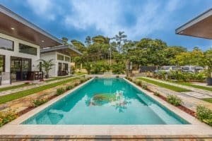 Turnkey Costa Rica property with a rectangular pool and modern poolside lounge.