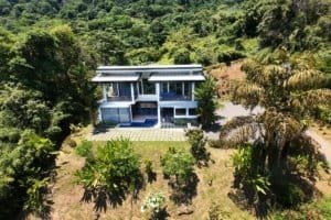 Modern 4-bedroom home with ocean views, pool, and lush garden in Dominical.