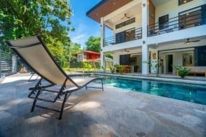 Condo with pool and lounge chair by the sea in Dominical Costa Rica.