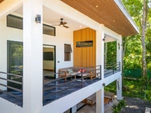 Dominical real estate ocean view condo with balcony and lush greenery.