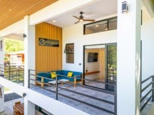 Ocean view condo terrace with seating and ceiling fan in Dominical Costa Rica.