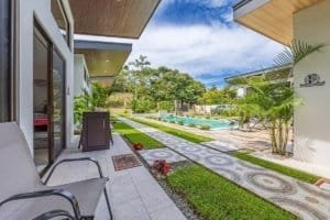 Outdoor pool area and modern villas with manicured lawn in Dominical Costa Rica.