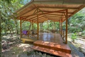 Wooden jungle hotel deck with lush forest surroundings in Dominical.