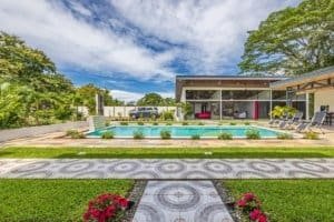 Turnkey investment home with pool, modern villa, outdoor lounge and landscaped yard in Dominical.