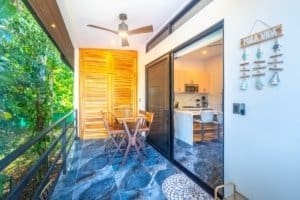 Ocean view balcony with seating and sliding glass doors to kitchen.