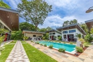 Dominical real estate villa complex with pool and modern houses.