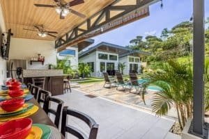 Outdoor living area with pool, lounge chairs, and modern villa in Dominical, Costa Rica.