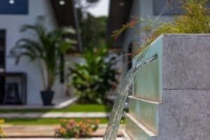 Water fountain detail at tropical Costa Rica estate with pool and greenery.