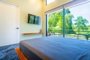 Dominical condo with ocean view, bright bedroom and balcony.