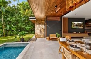 Luxurious jungle villa with pool, outdoor dining, and lush greenery in Dominical, Costa Rica.