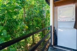 Dominical Costa Rica condo balcony with washer/dryer and lush tropical foliage.