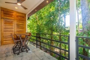 Ocean view balcony with table and chairs in Dominical condo.