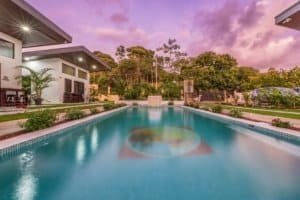 Turnkey 3-villa complex with large pool and modern outdoor lounge area.