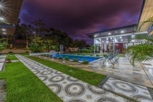 Turnkey Costa Rica villa with pool and modern patio at dusk.