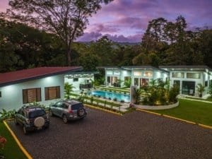 Turnkey villa complex with pool, lush landscaping, and off-street parking in Dominical.