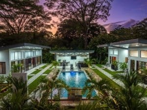 Turnkey 5-bedroom investment property with three rental villas and a two-bedroom home around a pool.