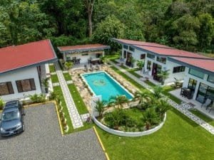 Dominical Real Estate: turnkey villa resort with central pool and lush tropical landscaping.