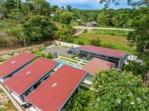 Turnkey rental villas in Dominical with red roofs and lush tropical grounds.