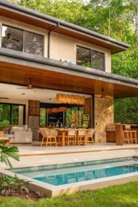 Luxury jungle home with patio, dining area, and crystal-clear pool in Costa Rica.
